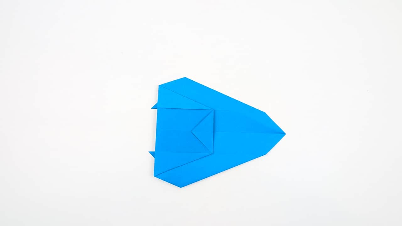 Fold the top point of the front layer downward to begin forming the head.