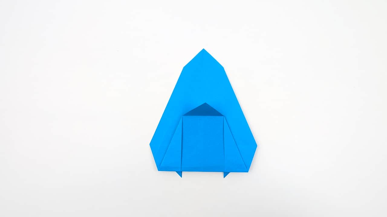 Fold the right side of the head section diagonally inward to narrow the nose.