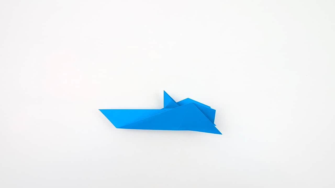 Fold the right pectoral fin point outward and downward.