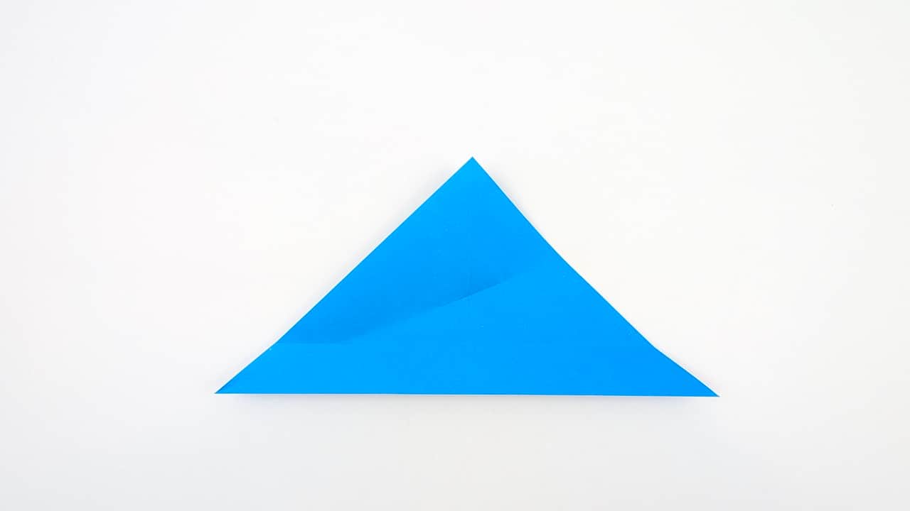 Fold the top right edge of the front layer down to the center crease.